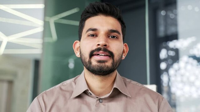 Webcam view. Bearded businessman talking on video call looking at camera sitting in office. Confident handsome entrepreneur has business meeting, speaks remotely at an online conference. Close up