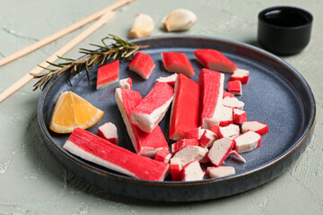 Plate with tasty crab sticks on light background © Pixel-Shot