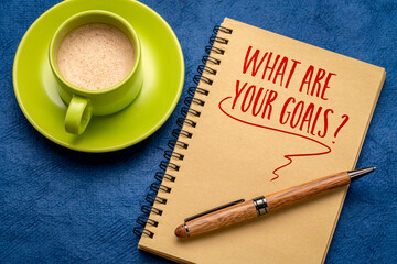 What are your goals? A question written in a spiral notebook. Resolutions and goal setting concept.