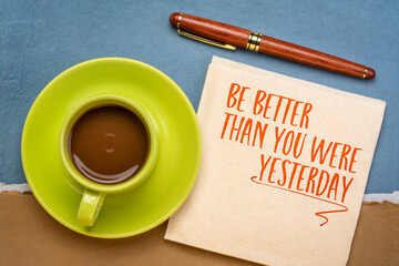 Be better than you were yesterday - motivational text on a napkin with coffee, personal development...