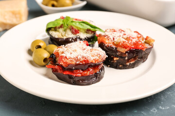 Plate with tasty baked Eggplant Parmesan on table, closeup