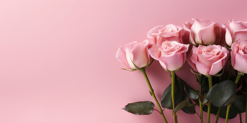 Fototapeta premium Greeting background with freshly pink roses flowerson a pink background . Festive banner for birthday, mother's day, March 8, anniversary.Flat lay, top view. Copy space. Mock up.