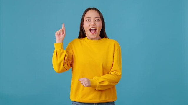 Focused female thinking and getting idea on blue background