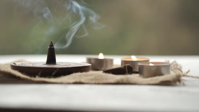 An incense cone burning and generating smoke.