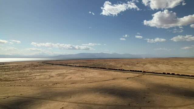 Drone Footage of Freight Train Through Desert Near Bombay Beach at Sunset, Riverside, California