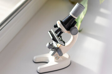 lose up shot of the microscope on the window. Science