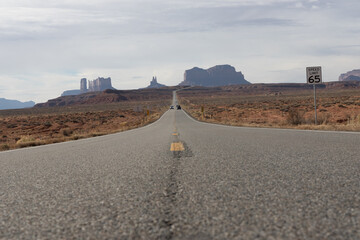 Road in the desert leading to rock formations