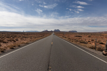 Road in the desert leading to rock formations