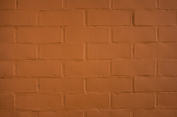 pared de ladrillos de color café con textura rugosa y con líneas verticales y horizontales 