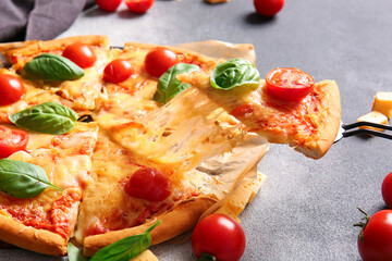 Baking paper with tasty pizza margarita on grey background