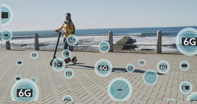 Animation of 6g text in circles over happy biracial woman riding electric scooter by the sea