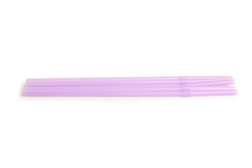 Purple plastic straws on white background