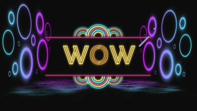 Animation of wow text in yellow neon and colourful neon rings on black background