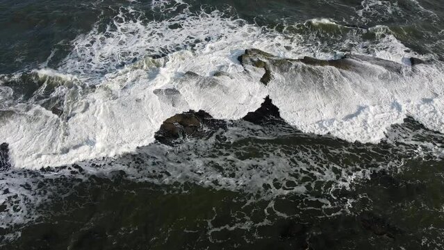 Aerial view of waves crashing onto a rock at the Filey Brigg  Peninsula in North Yorkshire