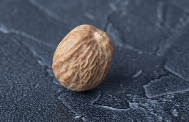 large dry nutmeg closeup on dark background