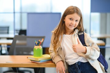 Confident smiling schoolgirl pupil student, standing at school