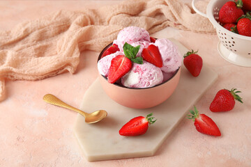 Bowl of delicious ice cream scoops with fresh strawberries and mint on pink table