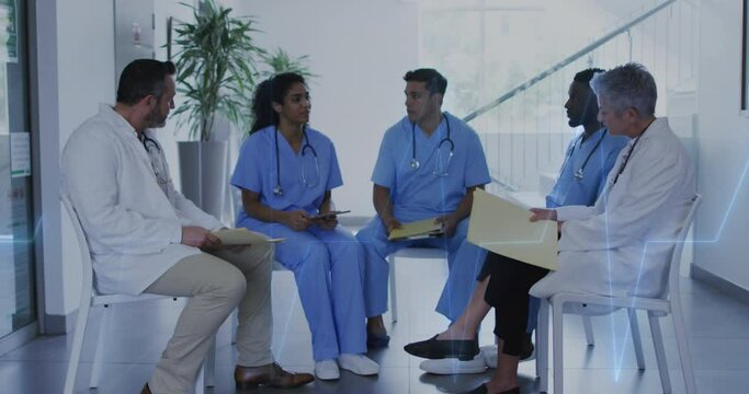 Animation of heart rate montior against team of diverse doctors discussing together at hospital