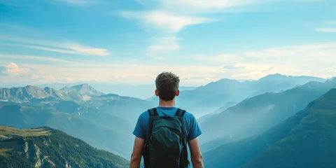 Fotobehang Happy young tall man with backpacks from behind standing and enjoying life in the mountains, man enjoying the view from top of mountain, close up back view. © BackgroundHolic
