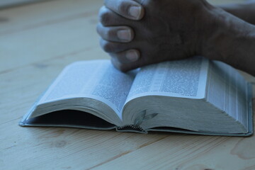 praying to God with the bible and cross stock image stock photo