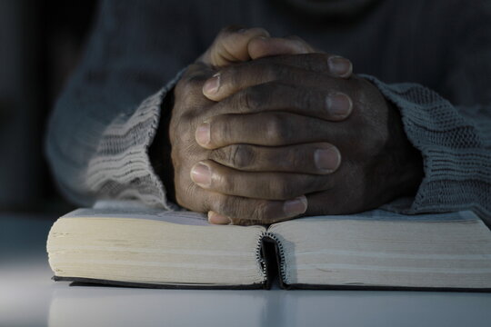 praying to God with the bible and cross stock image stock photo