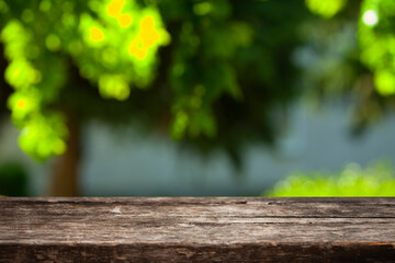 table background of free space for your decoration and blurred landscape. Blue sky with sunlight and green small leaves.