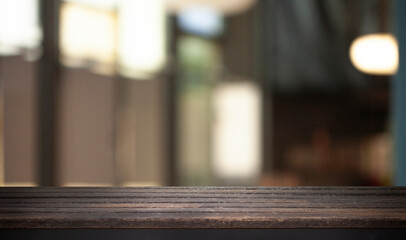 Empty dark wooden table in front of restaurant abstract blurred bokeh background. can be used to demonstrate or mount your products. Layout for space