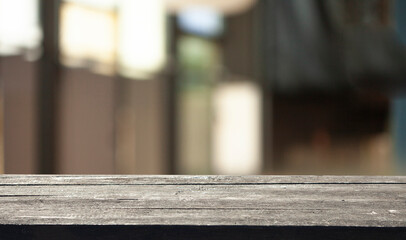 Empty dark wooden table in front of restaurant abstract blurred bokeh background. can be used to demonstrate or mount your products. Layout for space