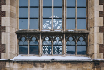 Pointed gothic windows with stained glass on facade of the building. Gothic architecture. Church of St. Olga and Elizabeth. Lviv, Ukraine.