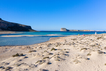 Amazing view of Balos Lagoon with magical turquoise waters, lagoons, tropical beaches of pure white sand and Gramvousa island on Crete, Greece
