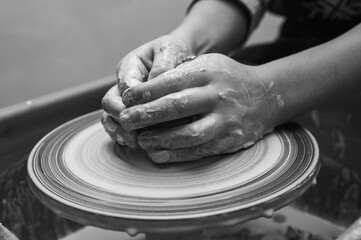 Black and white photo, clay, ceramics or hands in a design workshop working on an artistic cup or mug in a small business studio. Makes crafts in sculpture