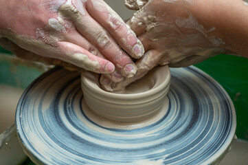 Clay, pottery or hands in designer workshop working on an artistic cup or mug mold in small business studio. Hand of creative artist or worker manufacturing handicraft products in sculpture