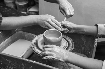 Black and white photo, clay, ceramics or hands in a design workshop working on an artistic cup or mug in a small business studio. Makes crafts in sculpture