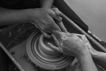 Black and white photo, clay, ceramics or hands in a design workshop working on an artistic cup or mug in a small business studio. Makes crafts in sculpture