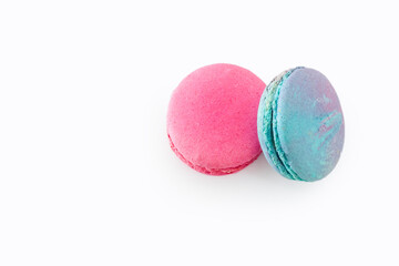 Tasty colorful macarons isolated on white background. Sweet macaroons dessert. Two multi-colored blue and pink macaroons. French pastry, almond cookies from egg whites.