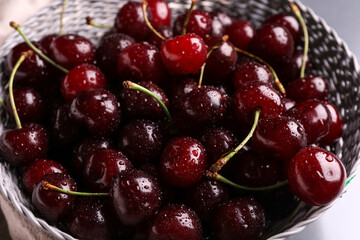 Wicker bowl with sweet cherries, closeup