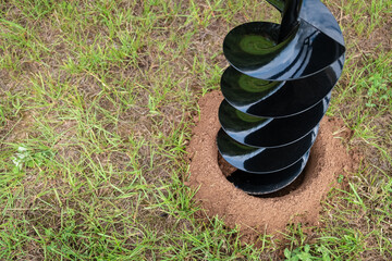 The drilled ground. The land hole. Borer for the fence installation. Bore tool. Portable manual...