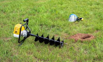 The drilled ground. The land hole. Borer for the fence installation. Bore tool. Portable manual...