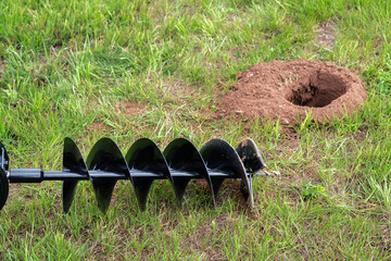 The drilled ground. The land hole. Borer for the fence installation. Bore tool. Portable manual...
