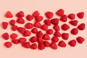 Many fresh raspberries on pink background
