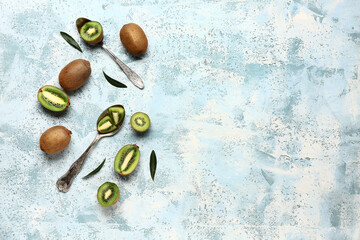 Fresh kiwi and leaves on light blue background