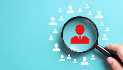 Human resources and management concept. Magnifier and business people icon on blue background.