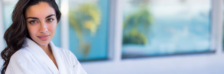 Obraz premium Portrait of a beautiful young woman in bathrobe at spa center