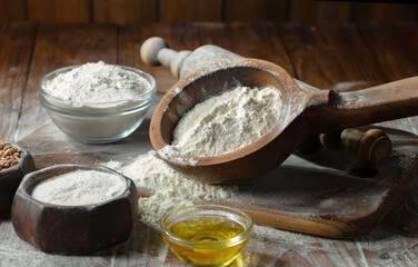 The process of kneading dough in the kitchen. Eggs, flour and other ingredients on the kitchen table in a composition.