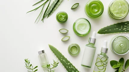 Fotobehang Flat lay of aloe skincare products, jars and bottles with aloe vera leaves on white background © Idressart