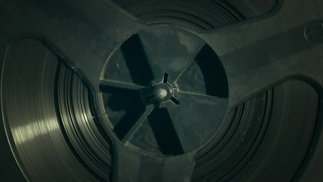 Extreme closeup of a vintage recorder reel. Closeup of a playing reel-to-reel recorder. Slowmotion, footage 4K. 