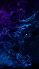 clouds of smoke of mixed blue and violet colors against black background