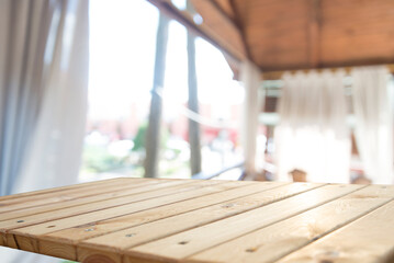 Neatly folded fresh red and white checked cloth conceptual of a country or rustic ambiance on a garden table in a sunny summer garden with focus to the napkin. High quality photo