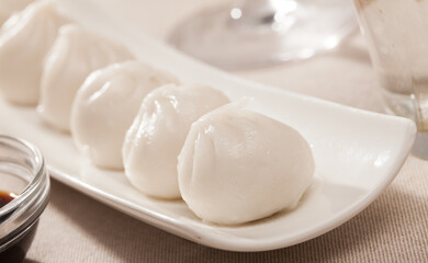 Fototapeta na wymiar Delicious chinese dumplings dim sum served on white plate