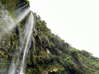 Looking up at a majestic waterfall in the jungle of Colombia